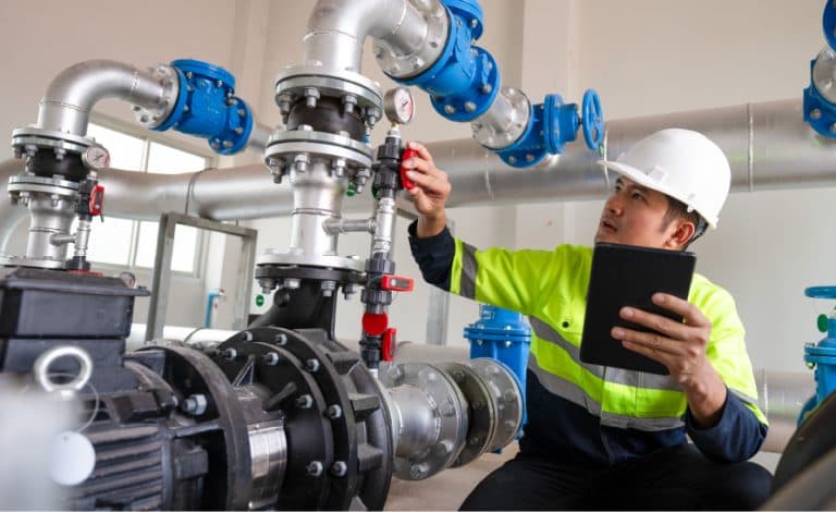 Field engineer inspecting pump-room valves